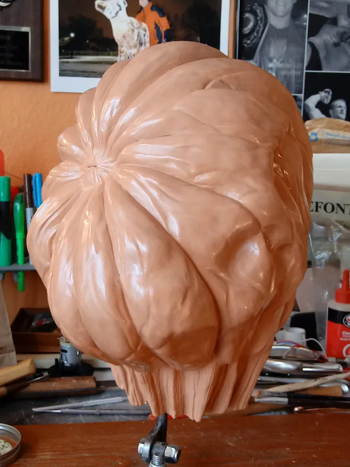 Clay sculpt of a pumpkin-character animatronic head