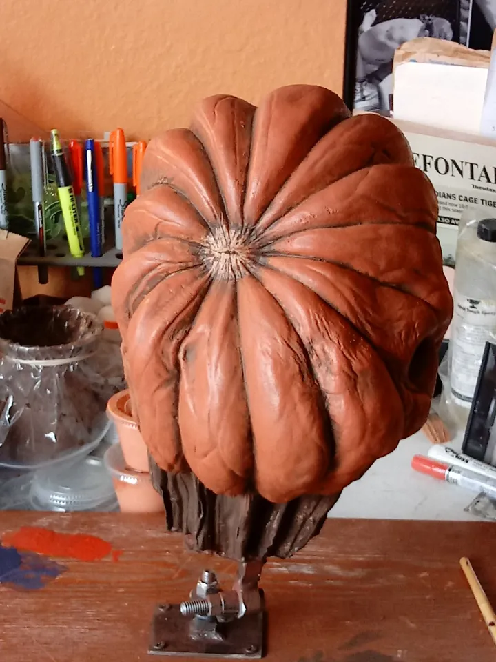 Cast latex pumpkin head on a sculpting stand
