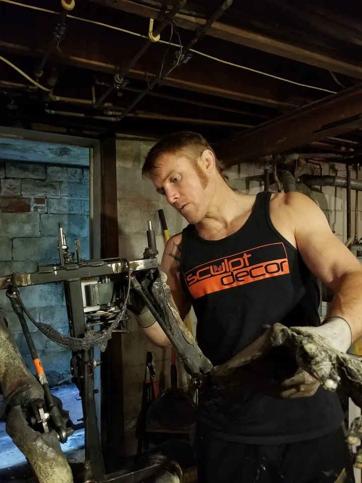 Dustin Weatherby repairing a Scare Factory zombie animatronic in his studio