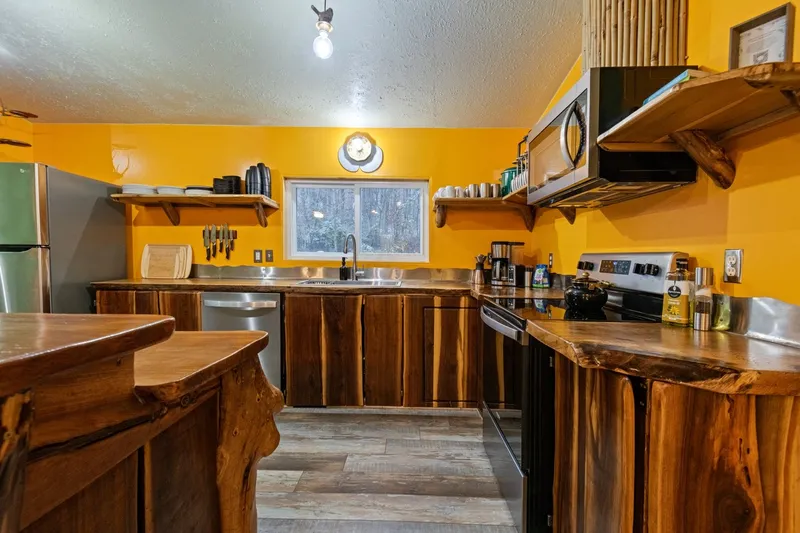 Custom kitchen with live-edge black-walnut cabinetry and countertops built by Dustin Weatherby