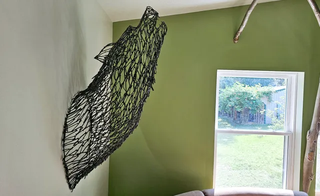 Coyote sculpture made from welded recycled nails, installed at Raven's Retreat