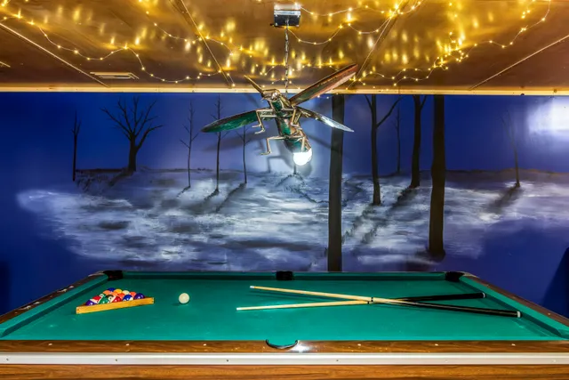 Custom metal firefly lighting fixture installed at Raven's Retreat Art Lodge